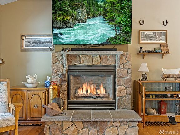 Warm propane insert with large stone hearth, stone mantle & fieldstone surround.