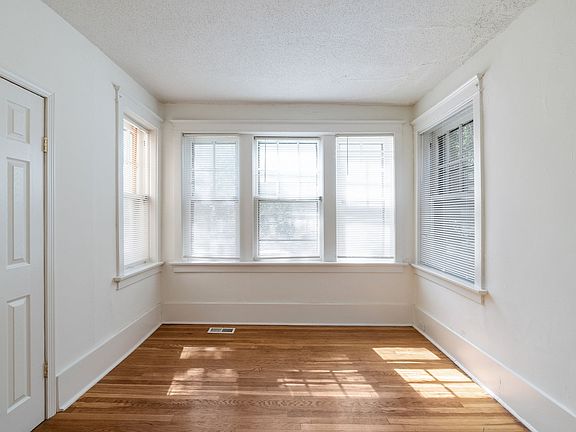 Brightly lit front bedroom with blinds to block sun and privacy. Closet is on to the left