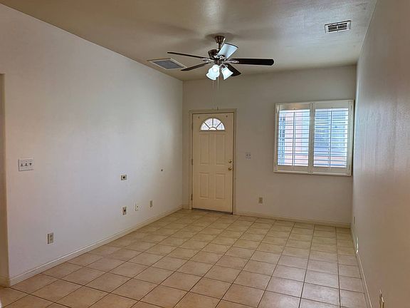 Living room and front door, view from kitchenette