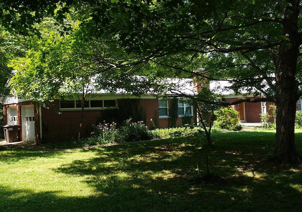 Newly updated home is nestled in a tree filled yard.