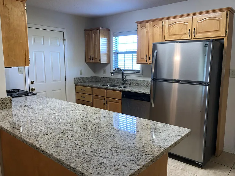 Granite counter tops and stainless steel appliances refrigerator, dishwash. built in microwave and washer dryer hook up.