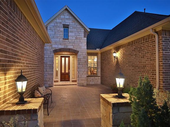 The extremey inviting front courtyard is a spectacular entrance to this David Weekley home! Situated on a cul-de-sac street, it's the perfect place to enjoy the outdoors with little traffic and at night a beautiful way to welcome your guests!
