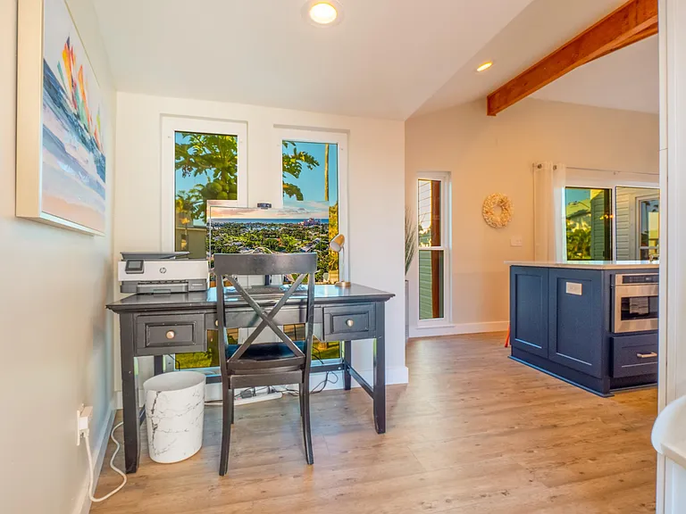 Dedicated home office area with desk, monitor, and printer.