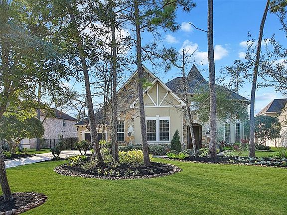 Another view of the fabulous front elevation - beautifully landscaped with mature trees.
