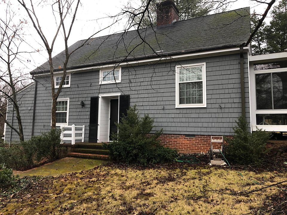 Newly painted grey Cape Cod; Sunporch (15x15) to R, new master suite out of view to L.