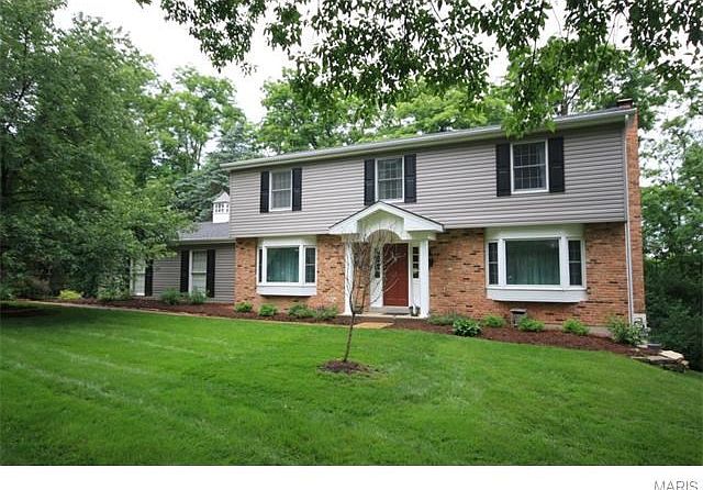 14521 Debbenham Lane a charming traditional home sitting on a private lot that backs to woods