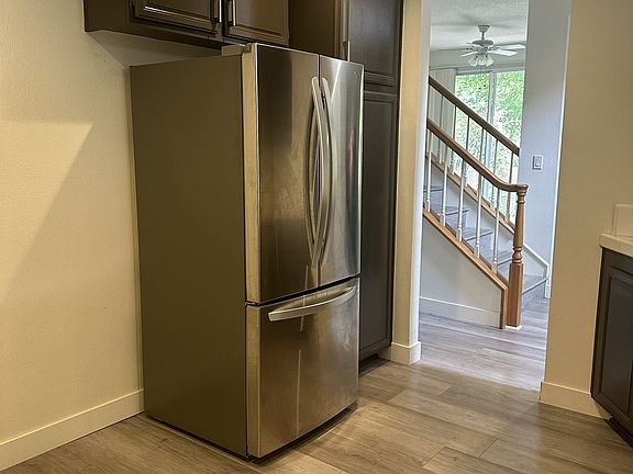 Kitchen (the view from the garage door through kitchen, the stairs, the family room area then the sliding door to the patio)