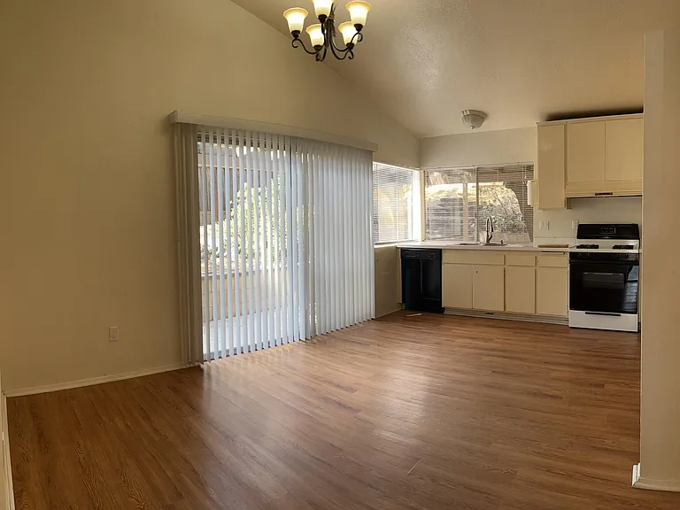 Large kitchen with refrigerator, dishwasher, stove. Large sliding door to side patio