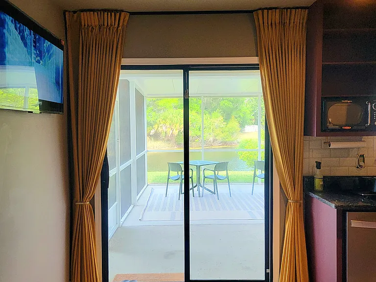Open kitchen area with a water view through sliding doors.