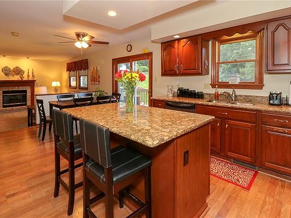 THE EAT-IN KITCHEN WAS UPDATED WITH NEW FLOORING AND GRANITE COUNTERTOPS.  ENJOY YOUR CUP OF COFFEE AT THE ISLAND OR USE IT AS A