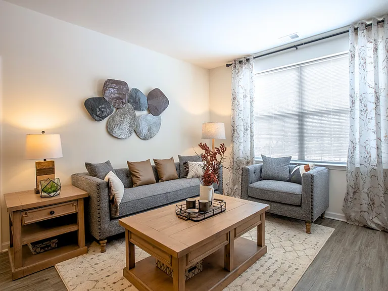 Modern, cozy living spaces with stylish decor, luxury flooring, and warm wood accents for a welcoming feel.