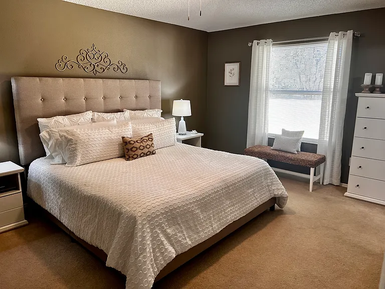 Primary Bedroom king bed, light and bright with a beautiful view of the pond across the street has a 32" TV.