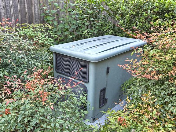 Briggs & Stratton 200amp generator on an elevated platform w/ an automatic transfer switch designed to handle this size of home, from top to bottom.