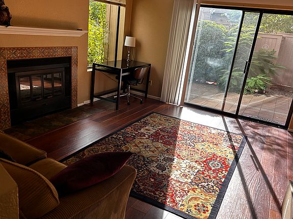 Spacious living room with sofa , rug and desk