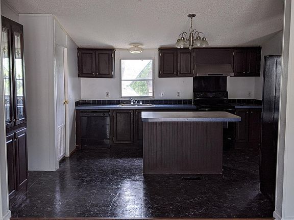 Kitchen with espresso cabinets and black appliances