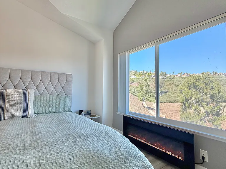 Primary Bedroom with fireplace & view