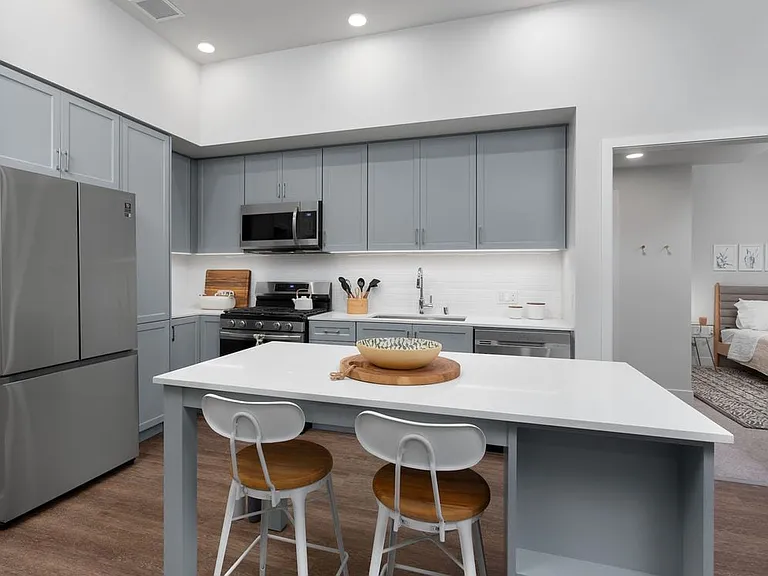 Building A Avalon Design kitchen with quartz countertops, stainless steel appliances, backsplash and island