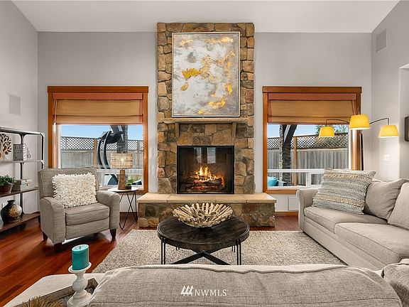  Show-stopping open great room concept with floor to ceiling stone fireplace