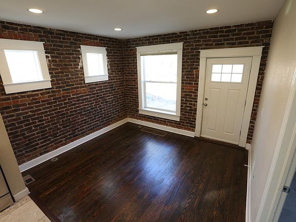 Living room with large east facing window and gorgeous exposed brick