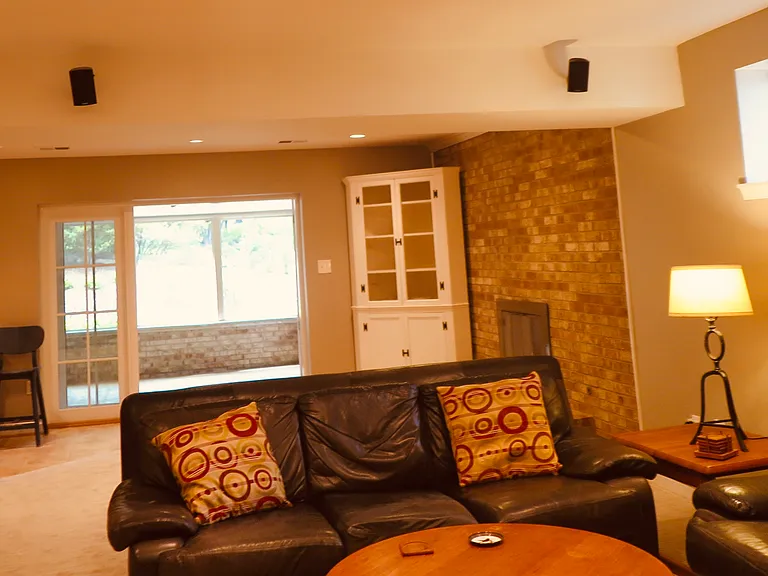 Lower level recreation room with screened porch in background.