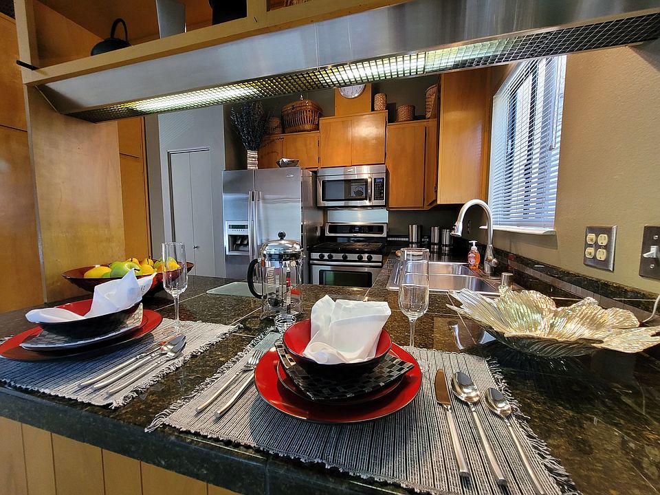 Fully equipped Kitchen with all stainless steel appliances and granite counters, designer light fixtures, and a three-speed ceiling fan