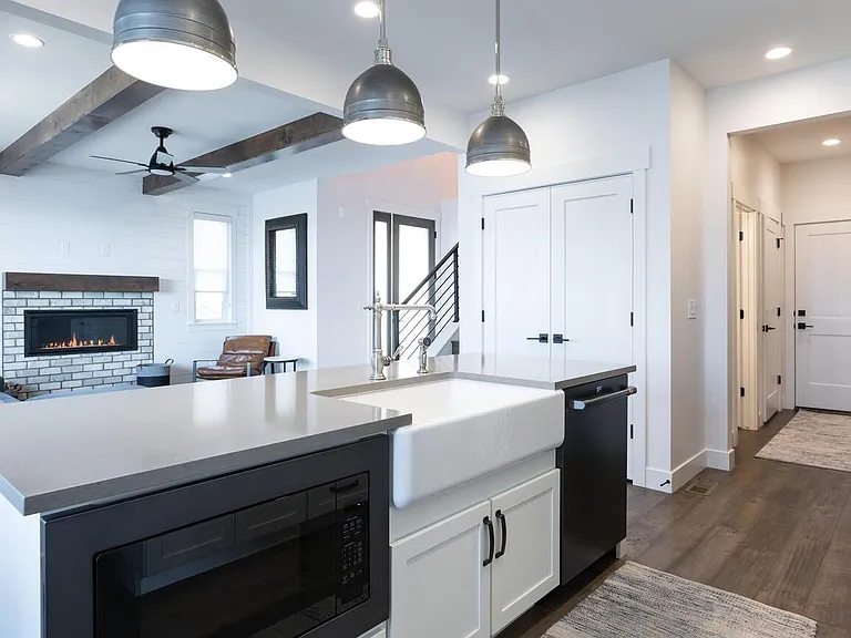 Kitchen Island with views of hallway to garage door and living room fireplace.