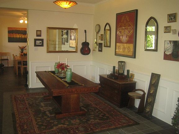 Formal dining area with slate floors, raised panels, steps from the kitchen.
