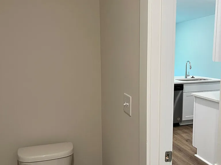downstairs half bath with view of kitchen