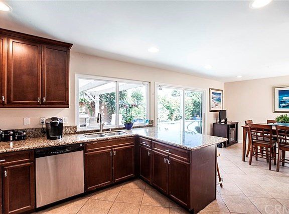 Kitchen open to large dining room with sliding glass doors out to the patio