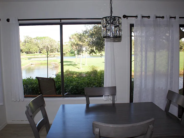 Kitchen table view of golf course, pond and water
