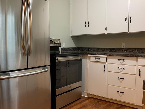Kitchen features brand new full sized refrigerator, stove, dishwasher and counter tops.