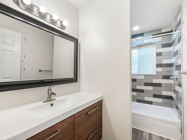Upper floor full bathrom with stylish vanity and tile work