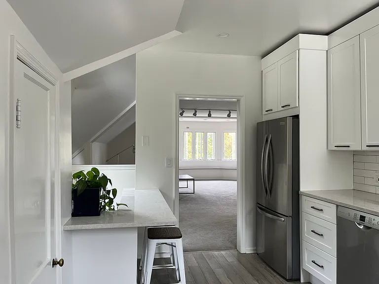 New fridge + dishwasher + amble cabinets + eat-in marble countertop in kitchen