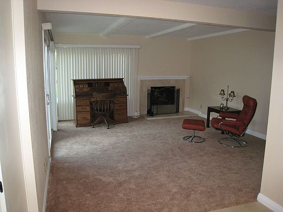 Cozy step-down living room with fireplace
