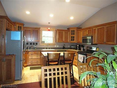 Kitchen with custom cupboards. Water faucet has reverse osmosis and on demand hot water.