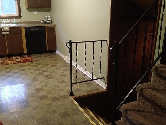 Kitchen -- stairs lead up to 3 bedrooms & 2 baths & other stairs lead down to family room & 1/2 bath