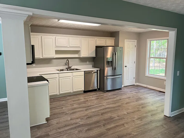 Kitchen includes fridge and stainless steel appliances