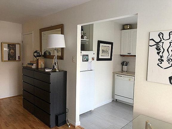 Interior view of kitchen toward bathroom door.