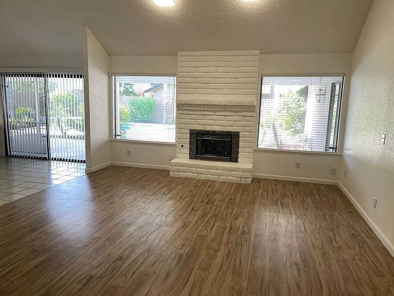 large living room with decorative fireplace.
