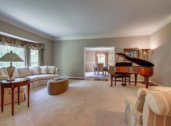 Large living room with multiple windows. Formal dining room shown off kitchen and living room.