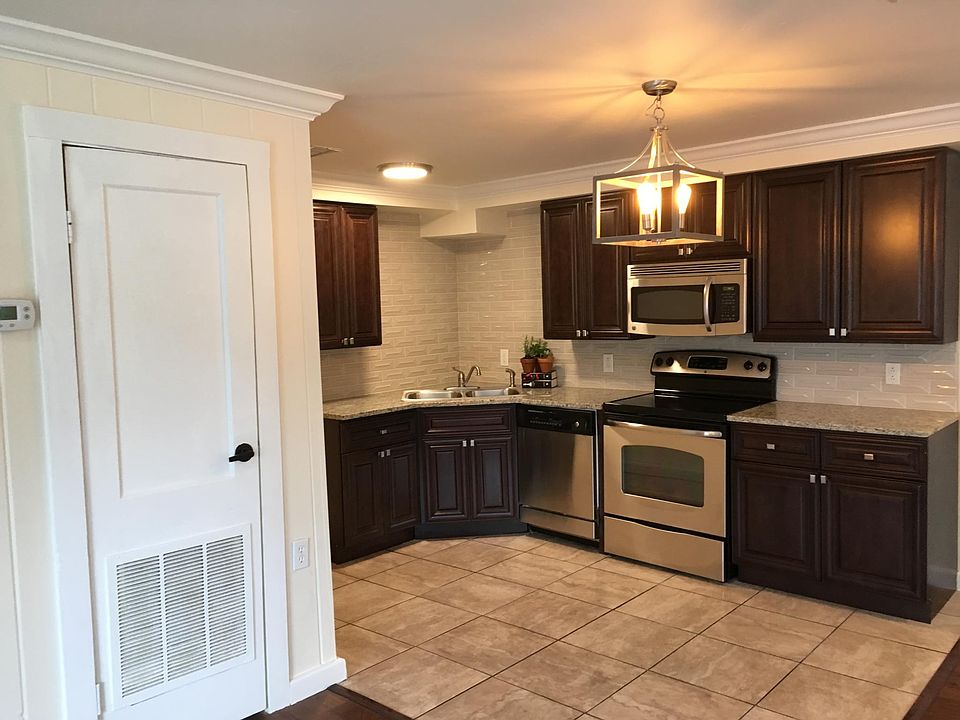 New cabinets, granite countertops, tile backsplash, and stainless steel refrigerator. Appliances include dishwasher, smoothtop range, microwave,and garbage disposal.