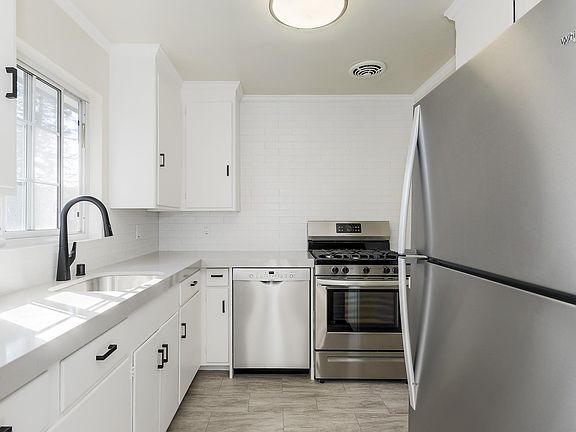 Remodeled kitchen with quartz counter tops and all new stainless steel appliances