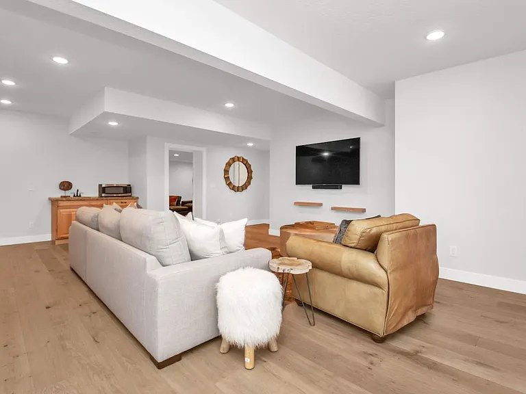 Basement living room with smart tv, sound system, and access to private hot tub and gas outdoor fire pit