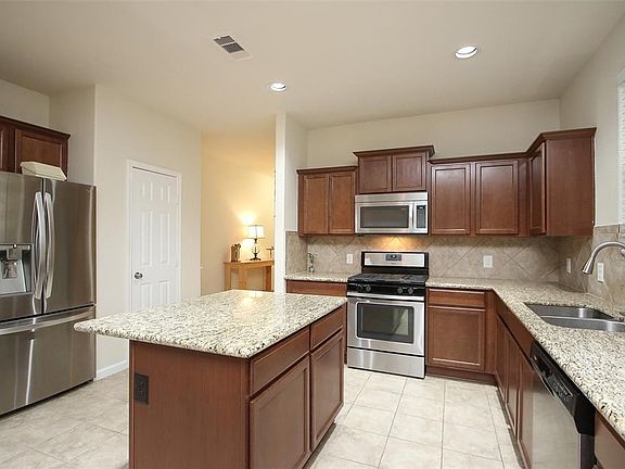 Large kitchen with an island and pantry! Lots of countertop space and plenty of cabinets!