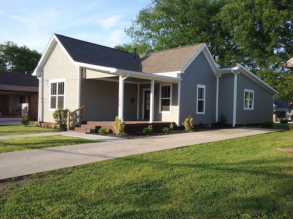 Concrete drive & walkway leads right-up ot patio, front and back