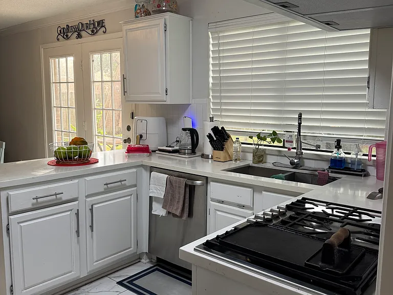 Kitchen with Jenn Air gas cooktop, wall oven and microwave, new quartz countertop and new sink