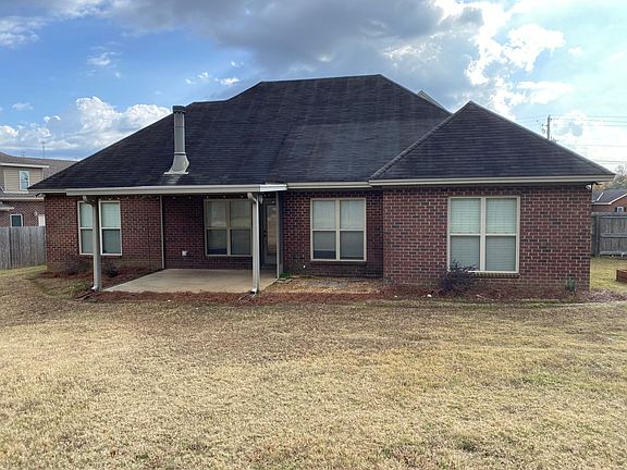 Spacious fenced-in backyard with covered patio.