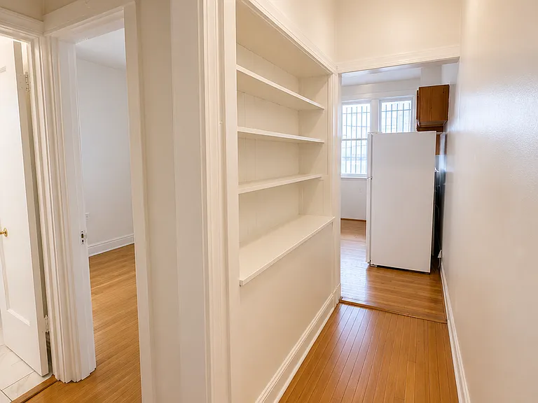 Built-in shelving to kitchen. 4th bedroom and 2nd full bath on left