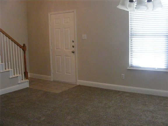 Enter into the dining/formal seating area with fresh new paint and carpet.