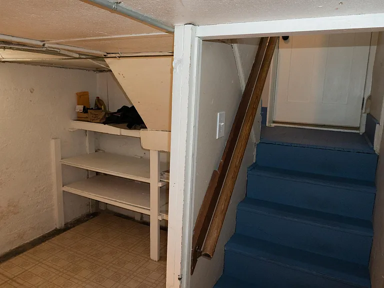 Basement storage shelves and stairway.
